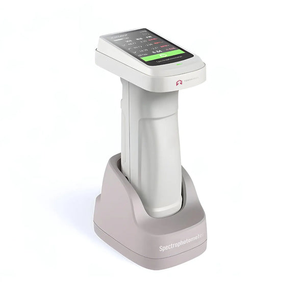 Portable color spectrophotometer with a digital screen and a calibration base, predominantly white with some gray and pink accents.
