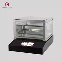 Transparent display case with digital display on a gray background, featuring the Torontotech logo.