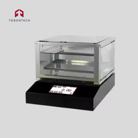 Torontech electronic device with digital display on a gray background